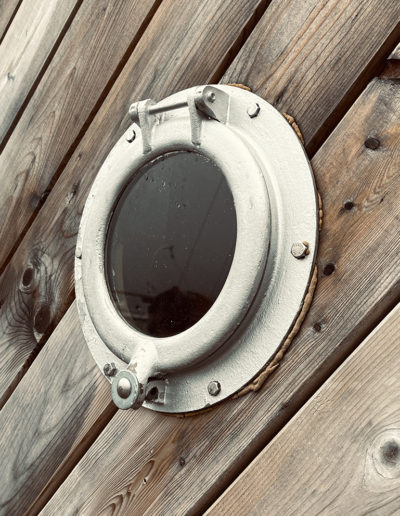 photo of porthole in wooden structure